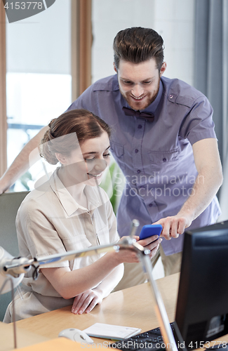 Image of business team with smartphone in office