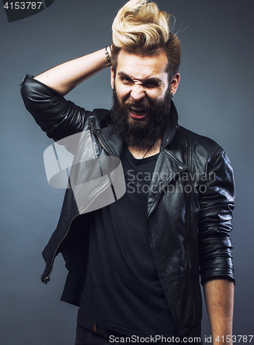 Image of young attractive bearded hipster man gesturing emotional screaming in studio sucsess
