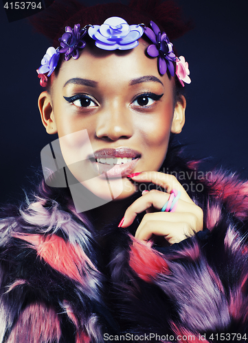 Image of young pretty african american woman in spotted fur coat and flowers jewelry on head smiling sweet etnic girl