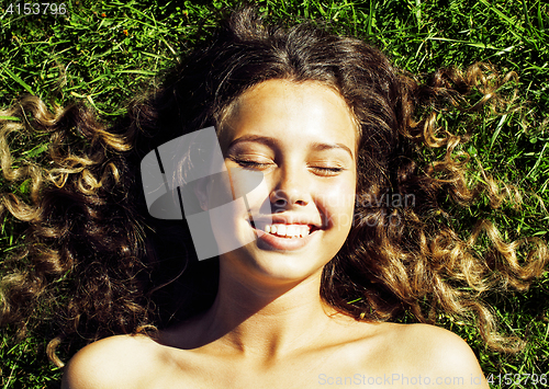 Image of young cute summer girl on green grass outside relaxing happy smiling close up, lifestyle people concept