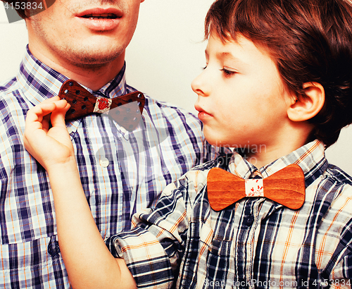 Image of father with son in bowties on white background, casual look