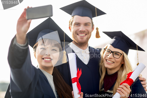 Image of students or bachelors taking selfie by smartphone