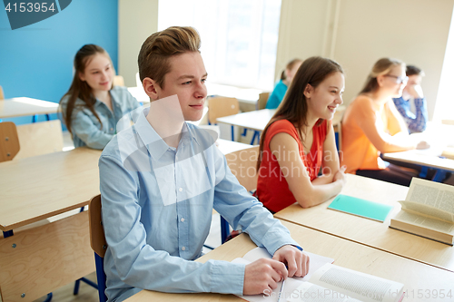 Image of happy student boy at school lesson