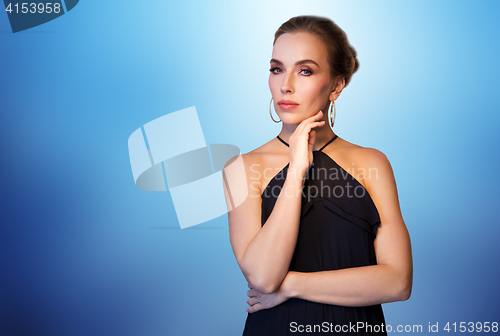 Image of beautiful woman in black wearing diamond jewelry