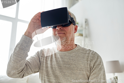 Image of old man in virtual reality headset or 3d glasses