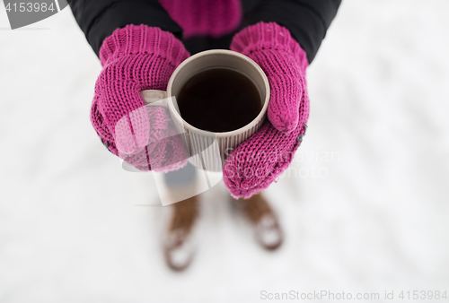 Image of close up of woman with tea mug outdoors in winter