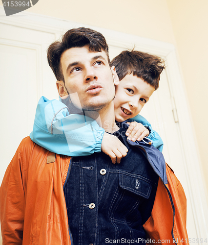 Image of young handsome father with his son fooling around at home, lifestyle people concept