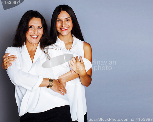 Image of cute pretty teen daughter with mature mother hugging, fashion style brunette, lifestyle people concept