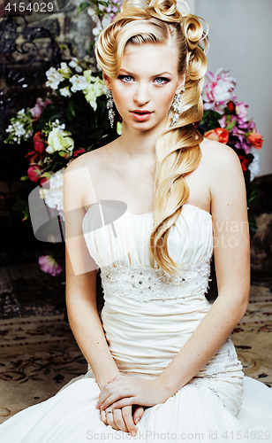 Image of beauty young bride alone in luxury vintage interior with a lot of flowers close up