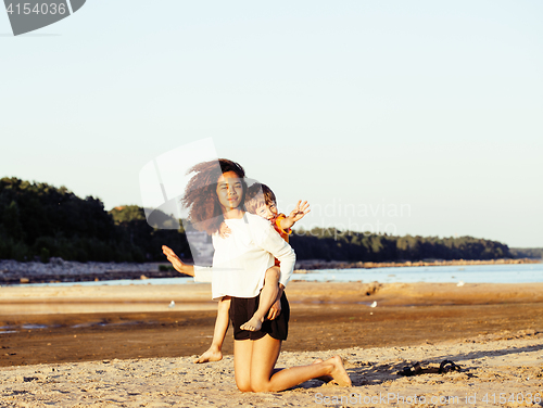 Image of pretty diverse nation and age friends on sea coast having fun, lifestyle people concept on beach vacations