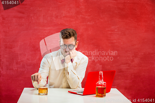 Image of Young funny man with laptop at St. Valentine\'s Day