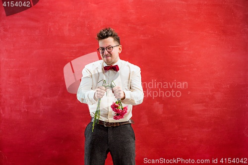 Image of Young funny man with broken bouquet