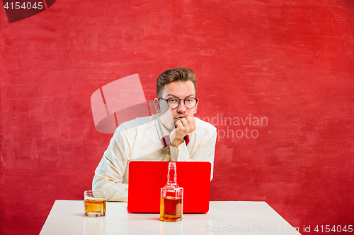 Image of Young funny man with laptop at St. Valentine\'s Day