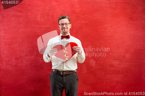 Image of Young funny man with abstract broken heart