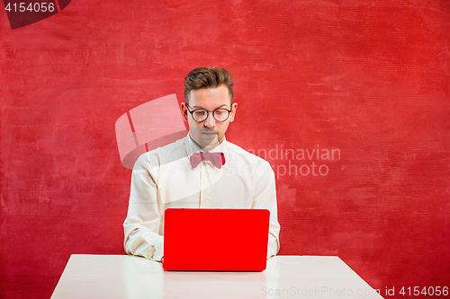 Image of Young funny man with laptop at St. Valentine\'s Day