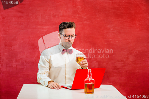 Image of Young funny man with laptop at St. Valentine\'s Day