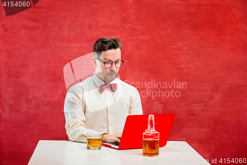 Image of Young funny man with laptop at St. Valentine\'s Day