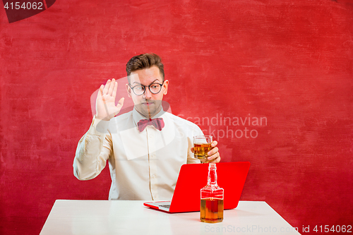 Image of Young funny man with laptop at St. Valentine\'s Day