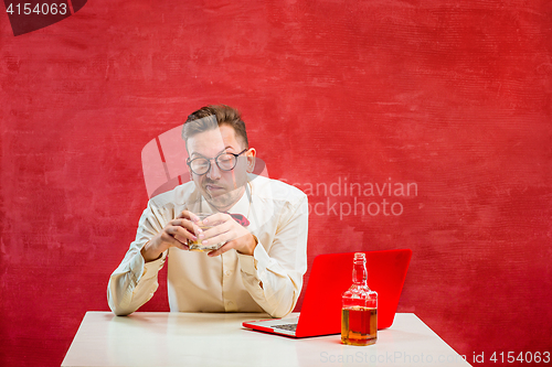 Image of Young funny man with laptop at St. Valentine\'s Day