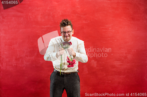 Image of Young funny man with broken bouquet
