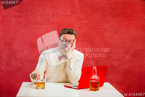 Image of Young funny man with laptop at St. Valentine\'s Day