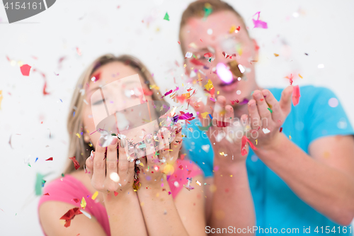 Image of romantic young  couple celebrating  party with confetti