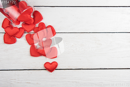 Image of Red hearts on a white wood background