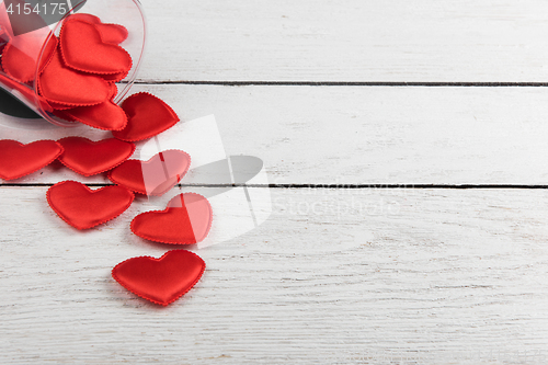 Image of Red hearts on a white wood background