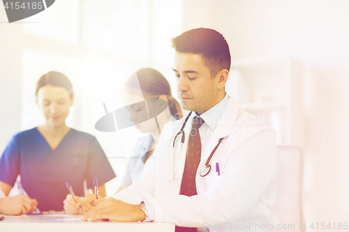 Image of group of happy doctors meeting at hospital office