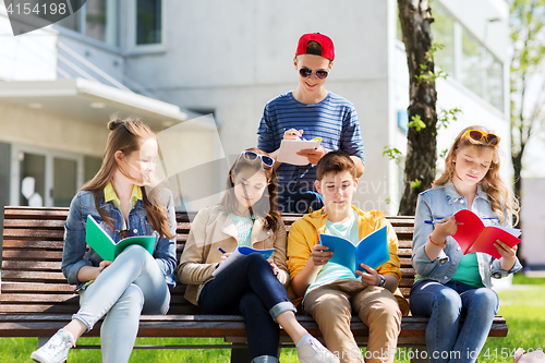 Image of group of students with notebooks at school yard