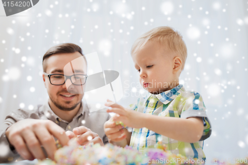 Image of father and son playing with ball clay at home