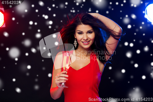 Image of beautiful woman with champagne glass at nightclub