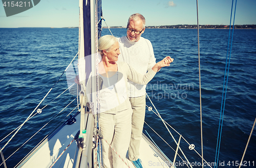 Image of senior couple hugging on sail boat or yacht in sea