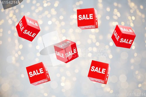 Image of boxes with sale signs over holidays lights