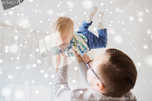 Image of father with son playing and having fun at home