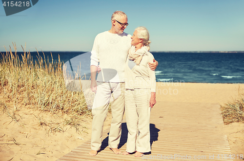 Image of happy senior couple talking outdoors