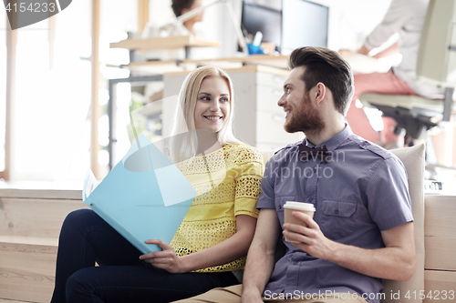 Image of office workers with folder and coffee