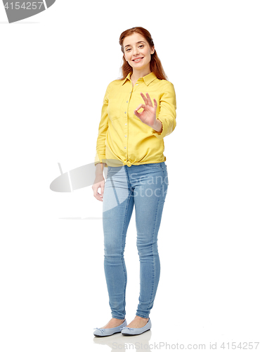 Image of happy young woman showing ok hand sign