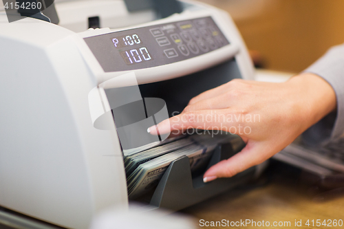 Image of dollars in electronic money counter at bank office