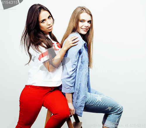 Image of best friends teenage girls together having fun, posing emotional on white background, besties happy smiling, lifestyle people concept, blond and brunette multi nations