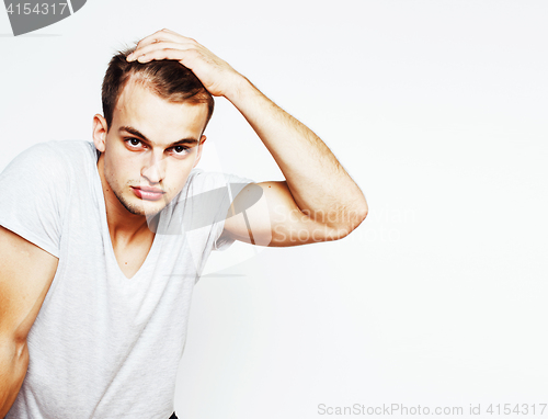 Image of young handsome man on white background gesturing, pointing, posi