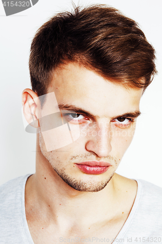 Image of young handsome man on white background gesturing, pointing, posi