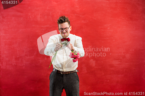 Image of Young funny man with broken bouquet