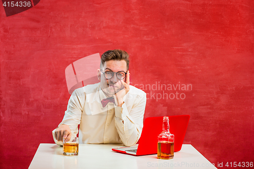 Image of Young funny man with laptop at St. Valentine\'s Day