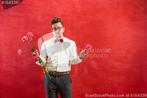 Image of Young funny man with broken bouquet