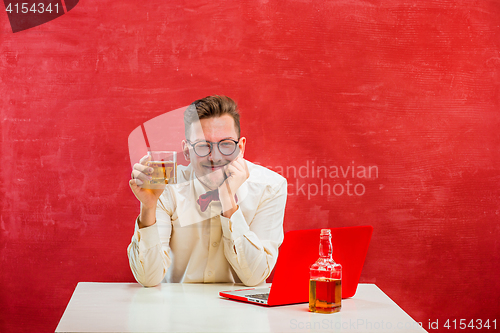 Image of Young funny man with laptop at St. Valentine\'s Day