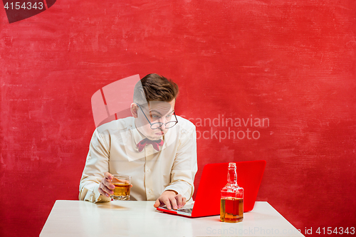 Image of Young funny man with laptop at St. Valentine\'s Day