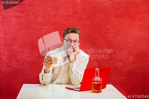 Image of Young funny man with laptop at St. Valentine\'s Day