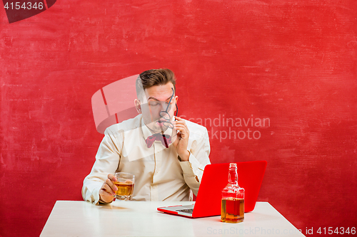 Image of Young funny man with laptop at St. Valentine\'s Day