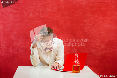 Image of Young funny man with laptop at St. Valentine\'s Day